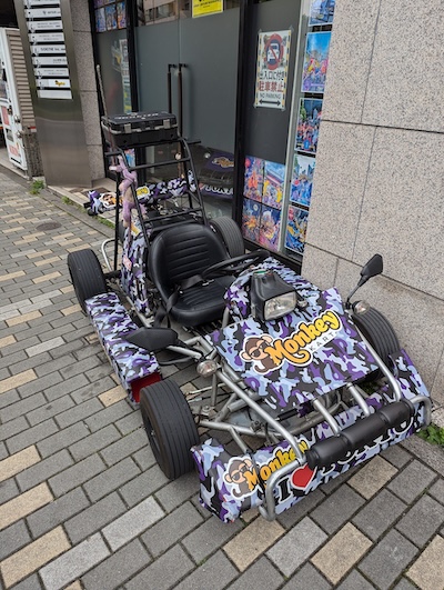 A purple camouflage Monkey Kart parked outside its Shibuya storefront